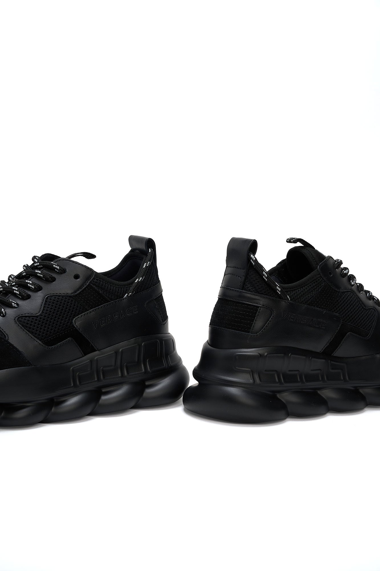 versace Pair of black sneakers on a white background