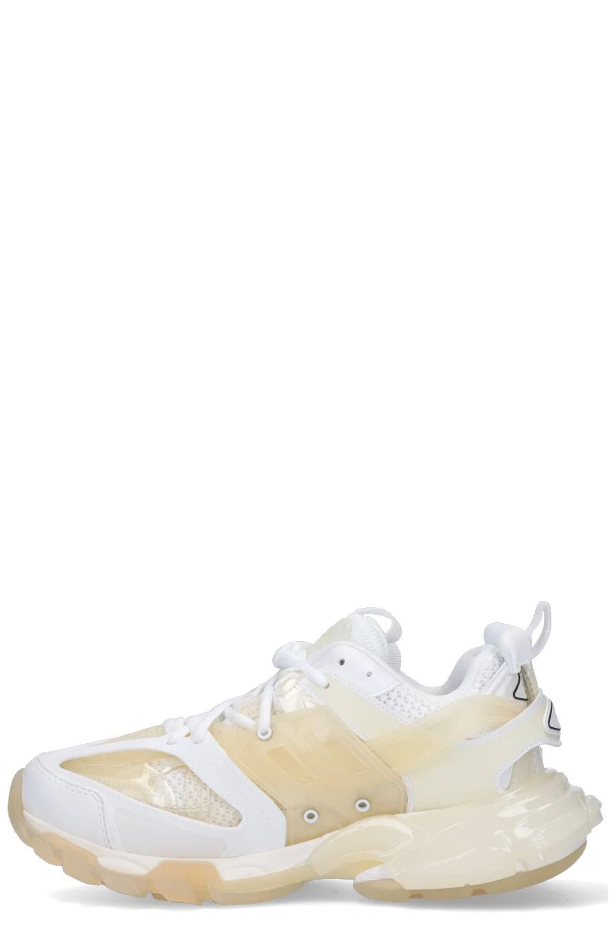 A pair of white Balenciaga Track Clear Sole sneakers with double tongue design and logo details.