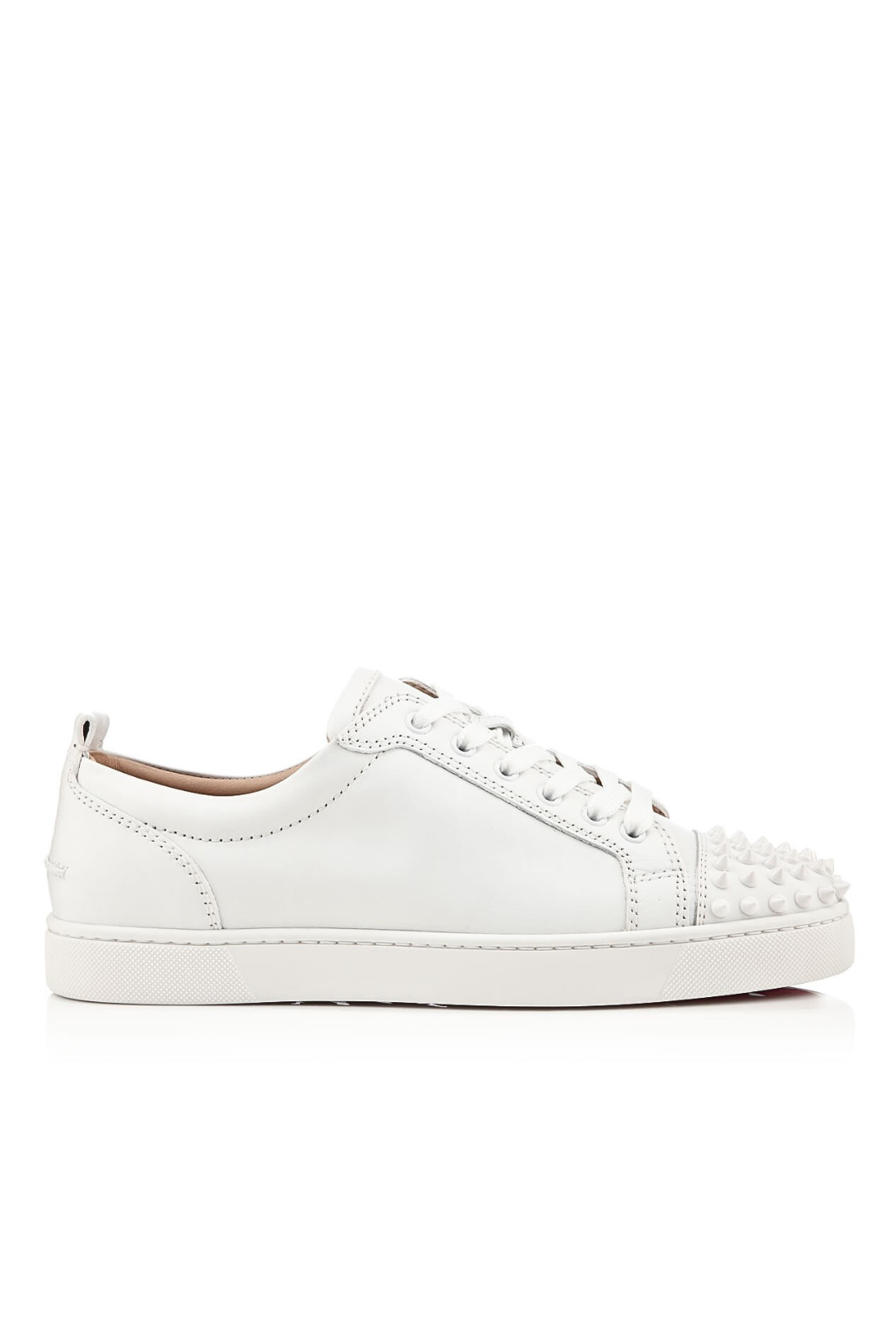 White Christian Louboutin Louis Junior Spikes sneakers with round toe and lace-up closure, made from calfskin leather.