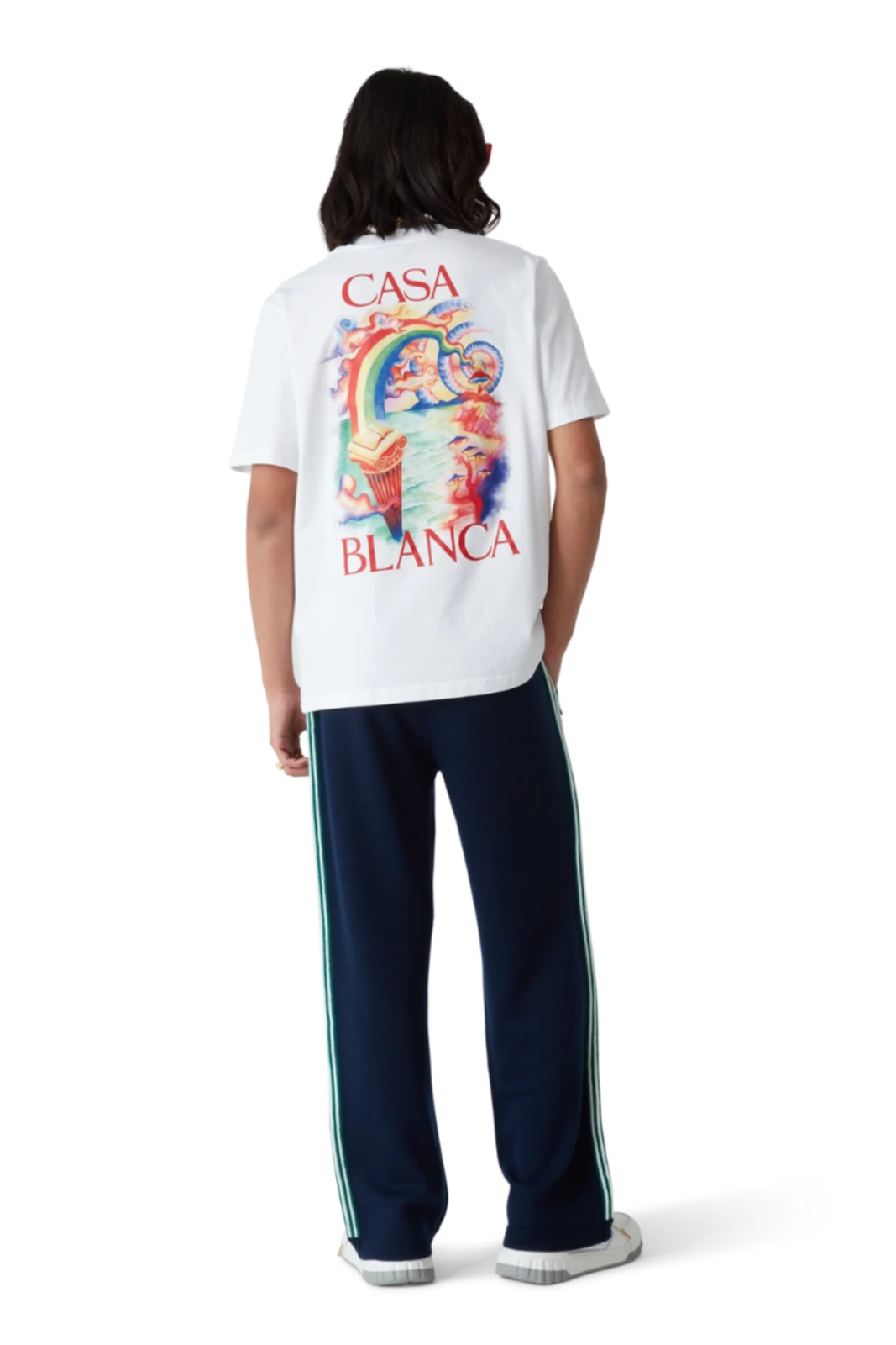 Person wearing a white t-shirt with colorful graphic and 'Casa Blanca' text on the back, standing against a white background.