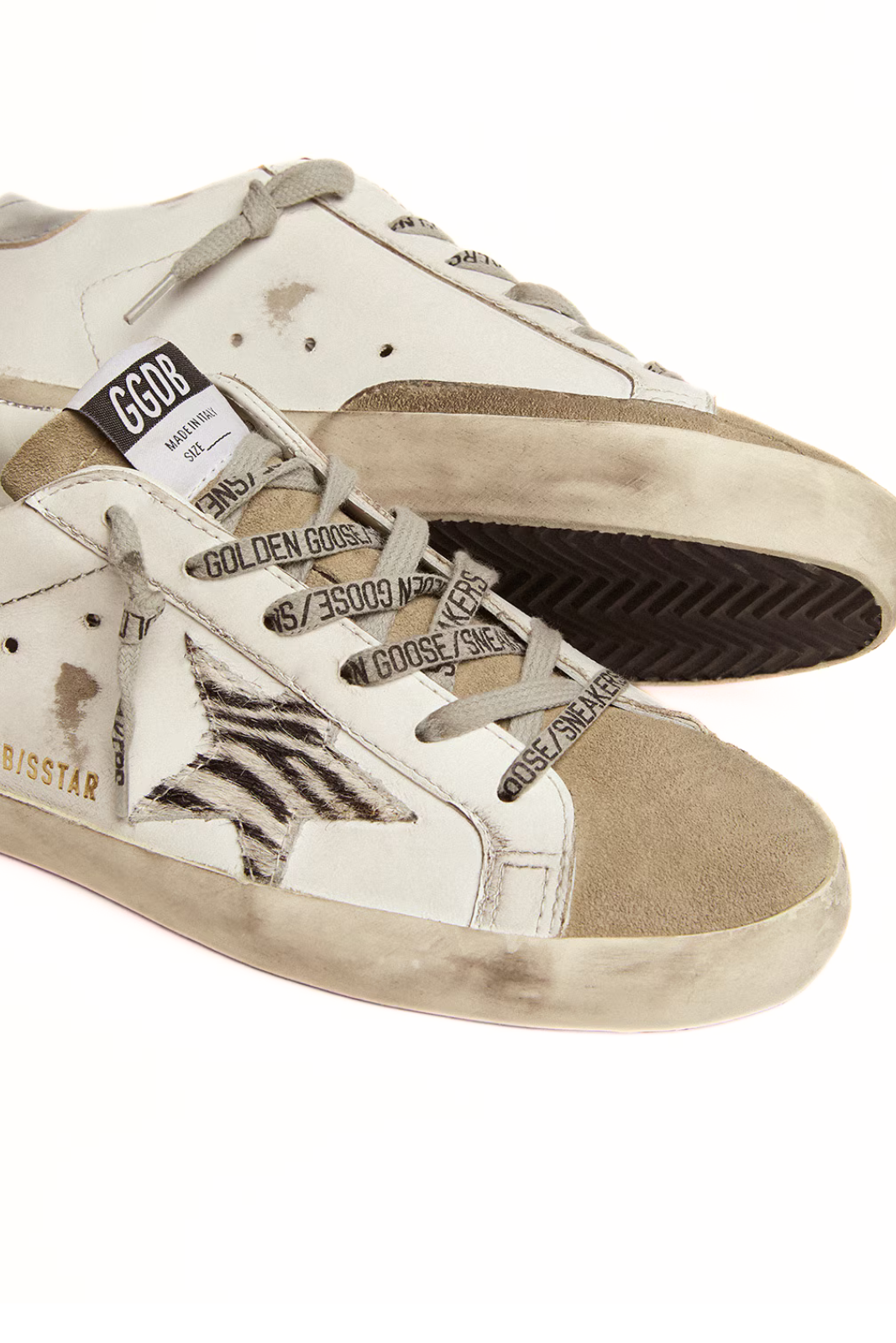 White and beige sneaker with star design and 'Golden Goose' branding on a white background